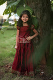 Little girls will look adorable in this traditional Indian ethnic maroon pattu pavadai sattai featuring cotton skirt and silk top.