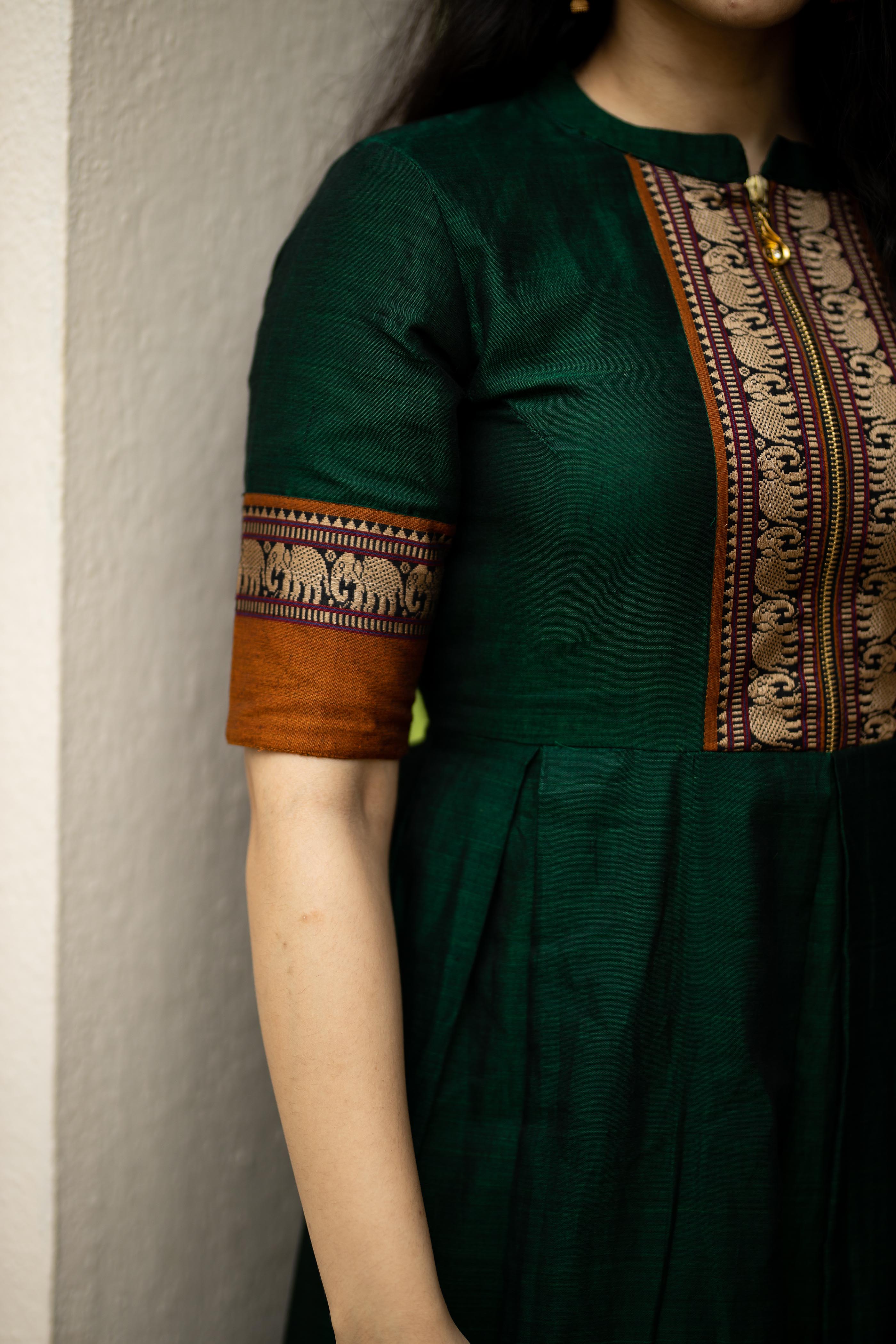 Look stunning in this beautiful green narayanpet cotton long dress with Sleeves and elephant motif borders. Crafted from pure cotton, this long, fitted collar neck dress is perfect for any special occasions.